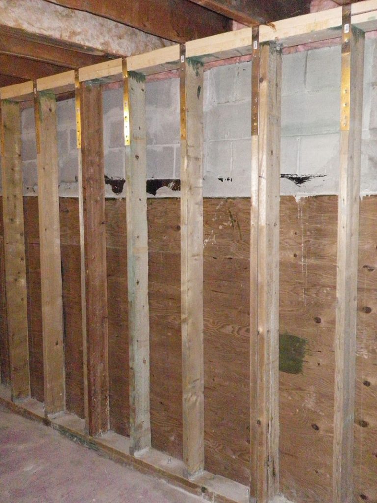 9 Wall plywood shim is installed up to grade level and top of wall is ...