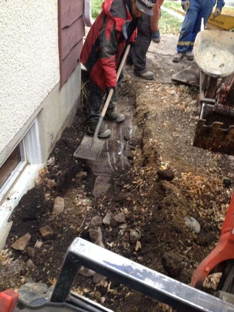 Professional foundation repair crew inspects structural damage on residential property before sale